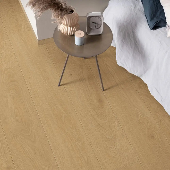 Pergo Visby Blush laminate flooring in a bedroom setting with side table