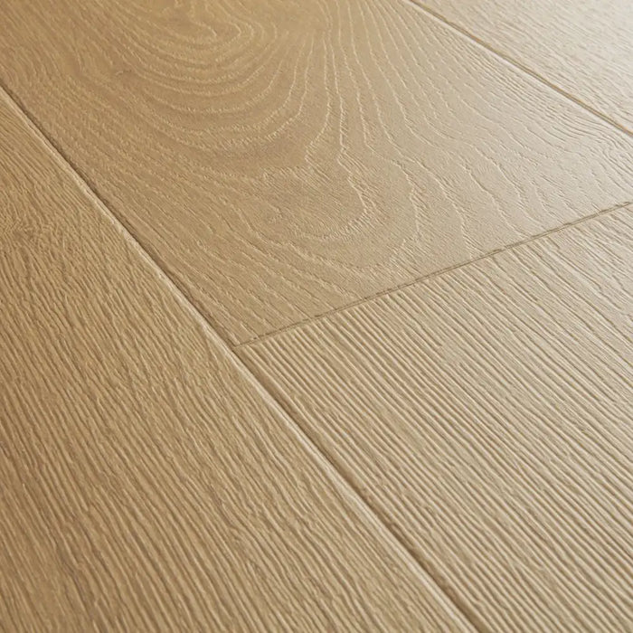 Angled close-up of Pergo Visby Blush oak laminate flooring grain and bevel