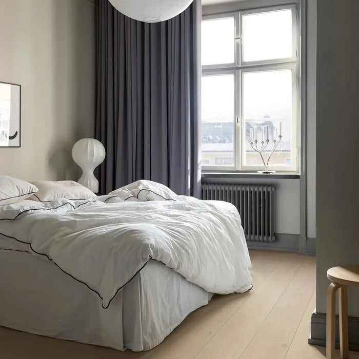 Pergo Visby Light Grey laminate flooring in a bright bedroom setting