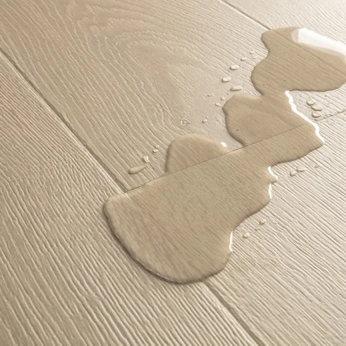 Water droplets beading on Pergo Visby Light Grey laminate flooring surface