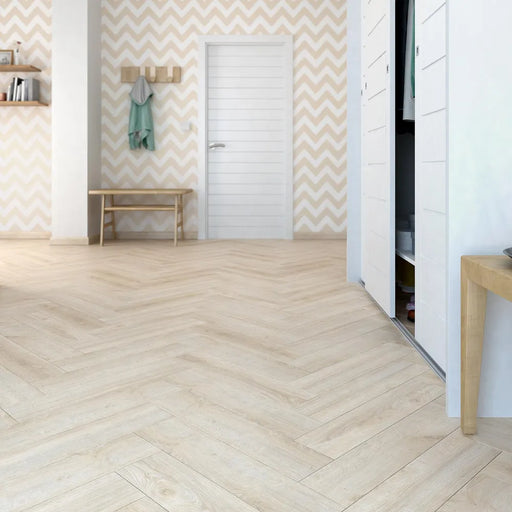 Waterford herringbone laminate flooring in a bright hallway with patterned wallpaper