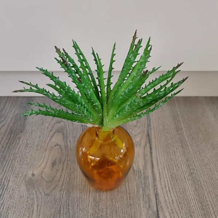Green artificial aloe succulent in a vase
