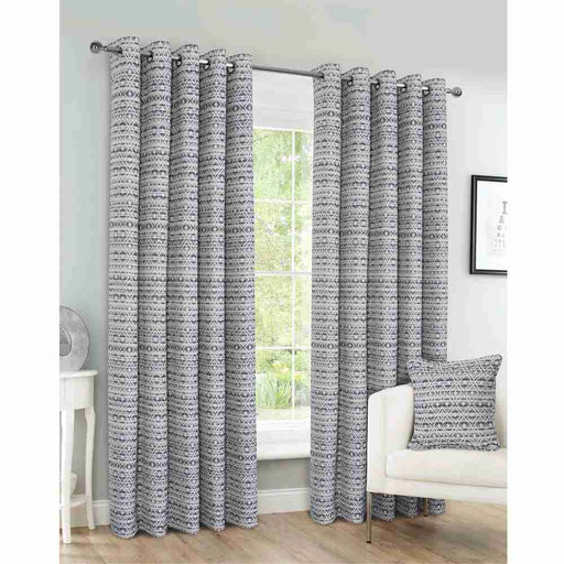 A living room window with Amelie contemporary geometric design curtains, in charcoal and grey