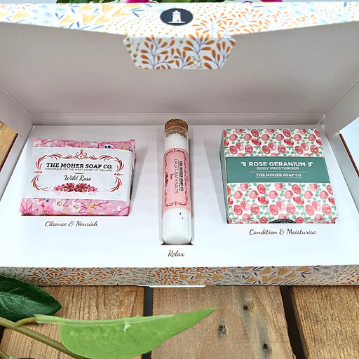 The simple yet beautiful Aran Evening gift box, filled with a Wild Rose soap, Rose Geranium body moisturiser and Uplift Rose bath salts in a glass vial