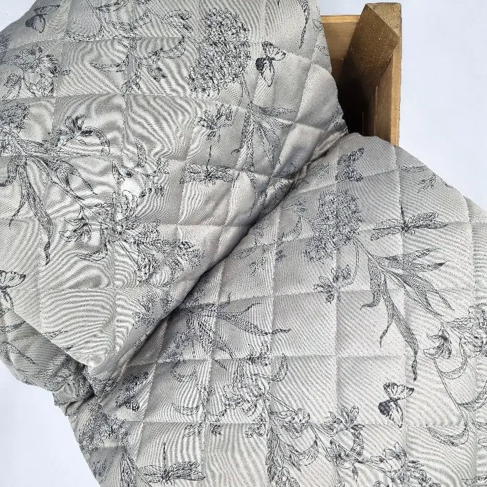 English countryside inspired jacquard Arboretum Gold quilted bedspread with piped edge, beautifully woven blossoms entwined with dragonflies and butterflies