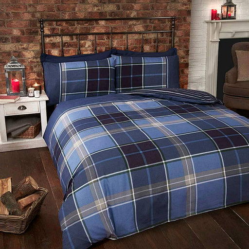 A bedroom setting with a double bed and Argyle Blue duvet set