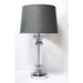 Arista table lamp featuring a textured grey shade and clear glass cylindrical stand with a chrome stem running through it