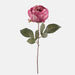 Artificial mauve peony flower on a stem with green leaves and faux thorns