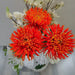 Artificial orange chrysanthemum in a bouquet