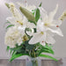A realistic faux cream lily stem in a bouquet