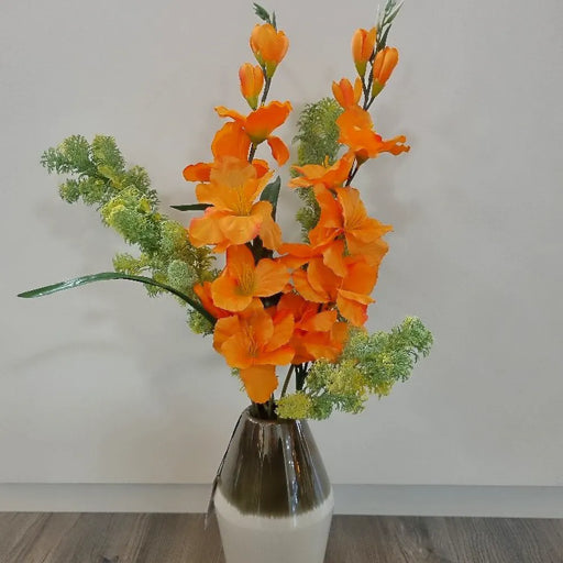 The Gladiolus twig features a large number of beautiful orange satin flowers