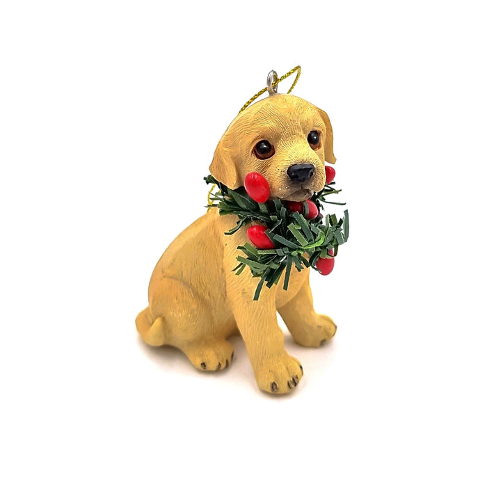 Sitting golden retriever puppy with Christmas wreath hanging decoration