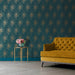 A decorative gold motif on a green background wallpaper in a sitting room
