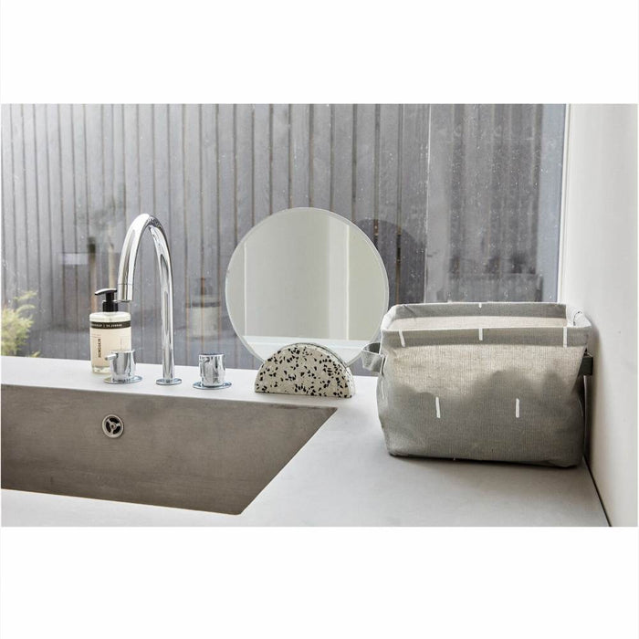 Bathroom sink with a HUBSCH grey and white storage basket