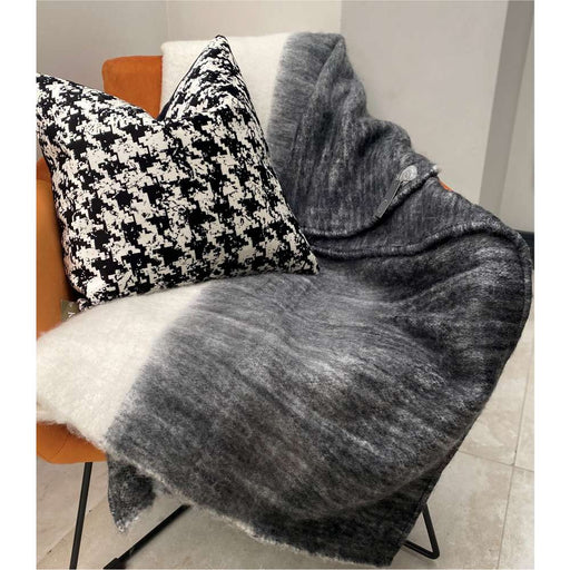A delicate, snug black, grey and natural large acrylic throw by Hübsch