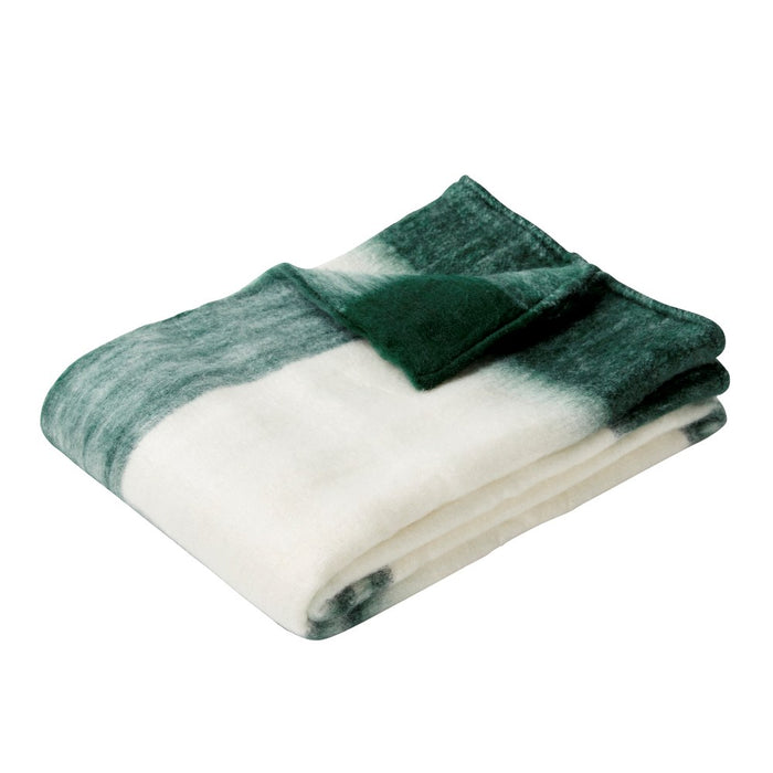 A delicate, snug green and white large acrylic throw by Hübsch