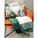 A delicate, snug green and white large acrylic throw by Hübsch