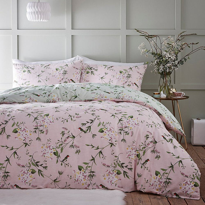 A bedroom setting with a double bed and Humming Bird duvet set
