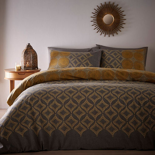 A bedroom setting with a double bed and Joel Ochre duvet set