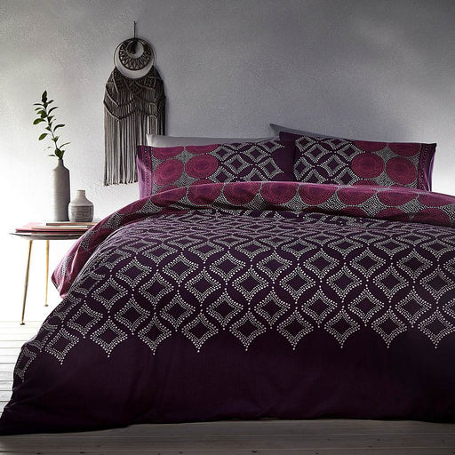 A bedroom setting with a double bed and Joel Plum duvet set