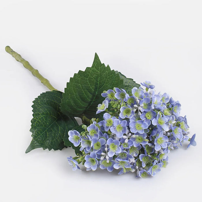 Artificial blue hydrangea flowers on a green stem with green leaves