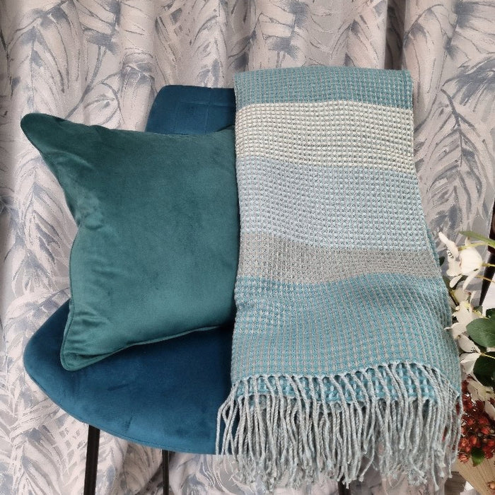 A beautiful double layered grid pattern woven Loire teal throw, with shades of teal and fringing