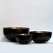 Mixology decorative bowls featuring a combination of black and warm metallic tones