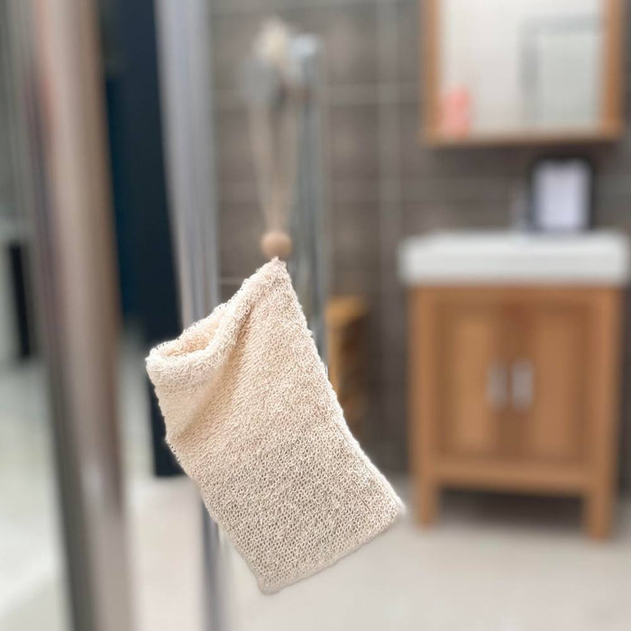 Nature Soap Bag Rami hanging on shower door.