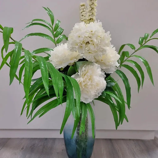 Artificial palm green stem in a bouquet