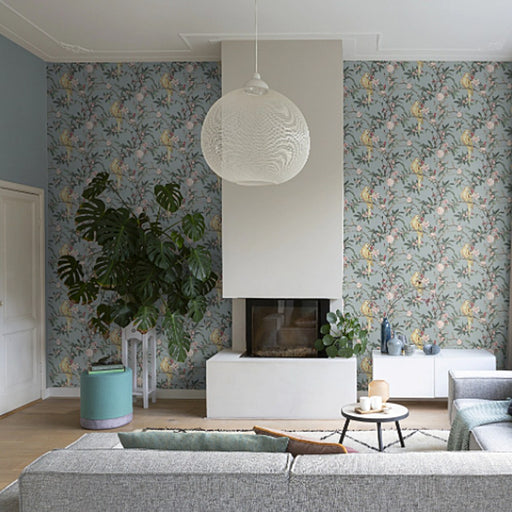 Breezy pastel shades foliage on a textured, fabric-feel background wallpaper in a sitting room
