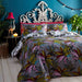 A bedroom setting with a double bed and Safari Jumble duvet set