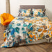 A bedroom setting with a double bed and Scatter Box Amber Teal duvet set