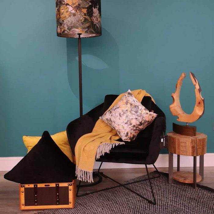 A living room setting with a black occasional seat and Scatter Box Aristo vibrant contemporary design cushion on cut length velvet with a luxurious ochre velvet reverse and knife edge finish