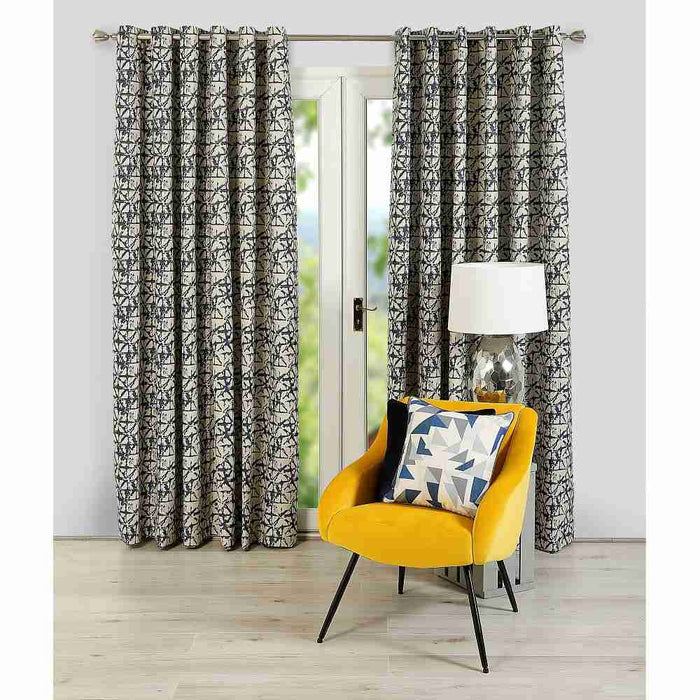 A living room window with Scatter Box Sigma navy, damask design curtains