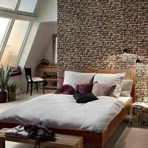 A bedroom with beige, brown and black, stone effect wallpaper
