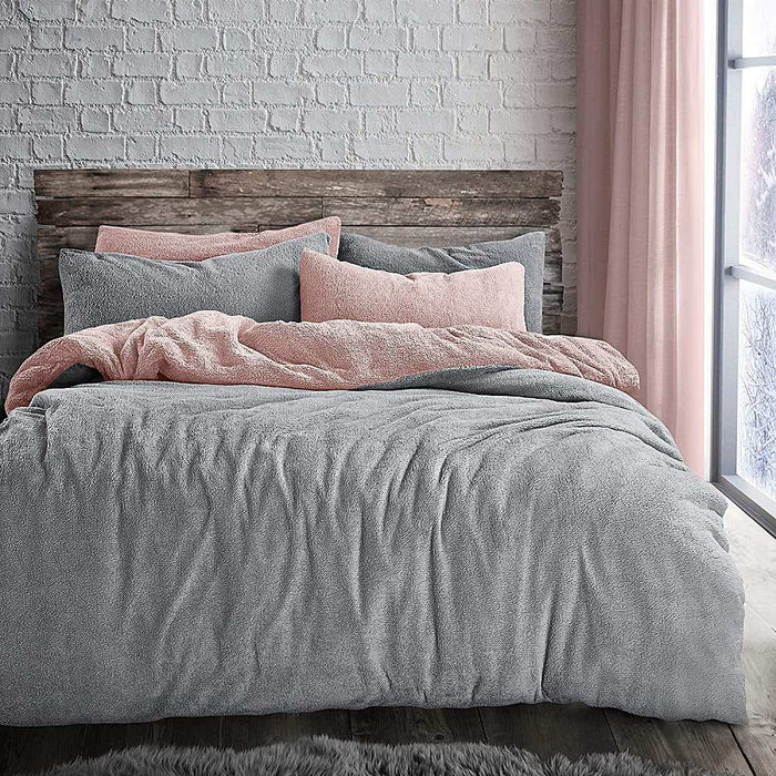 A bedroom setting with a double bed and Teddy Pink & Grey duvet set