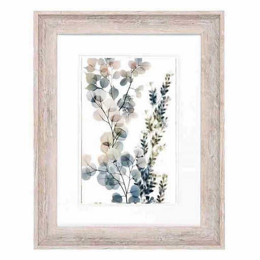 A green, blue and pink foliage print in an antique white frame