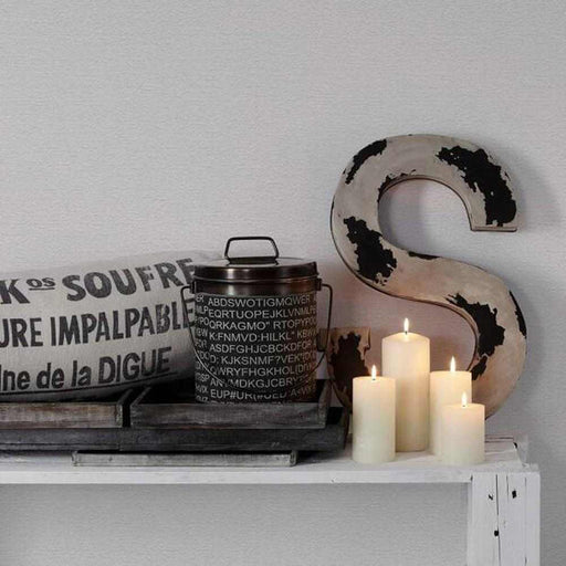 Paintable white wallpaper setting with candles and home accessories
