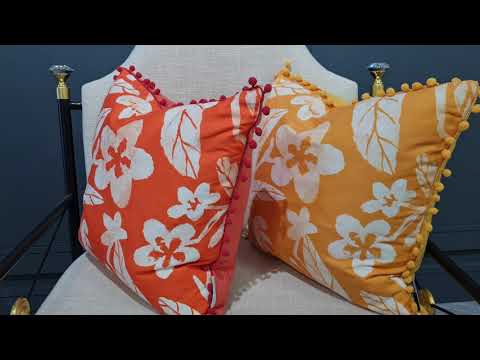 Hawaii vibrant orange floral print cushion with pom pom edging